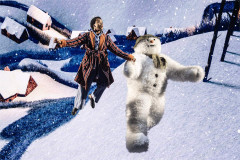 The Boy and The Snowman fly over snow-covered rooftops in The Snowman at Birmingham Rep. Photo by Johan Persson