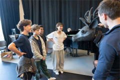 Three of the boys sharing the role of The Boy meet the stag puppet in rehearsal for The Snowman. Photo by Johan Persson