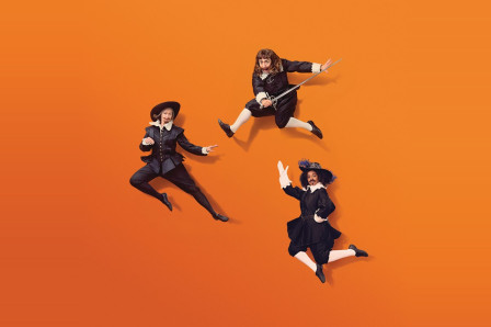 Campaign artwork for The Three Musketeers at the Royal Shakespeare Theatre: three musketeers in seventeenth-century costume leaping against an orange background