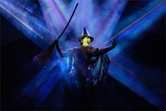 Elphaba takes flight with her broom in Wicked. Photo by Mark Senior