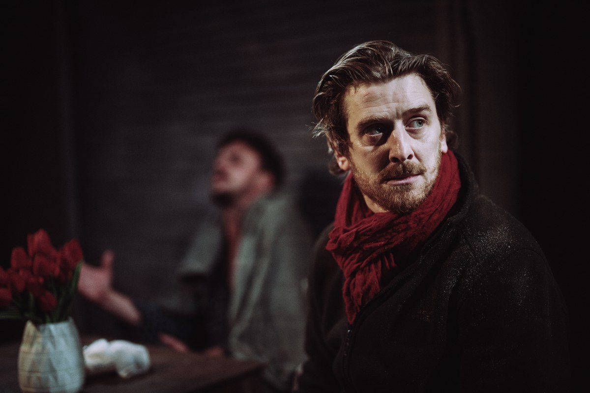 Ian Toner as Reece, with Ross Gaynor as Ashton behind him, in A Slow Fire at Jermyn Street Theatre