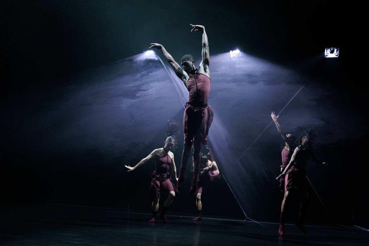 A dancer is lifted high under crossing spotlights in Andonis Foniadakis’s Pearls for Acosta Danza