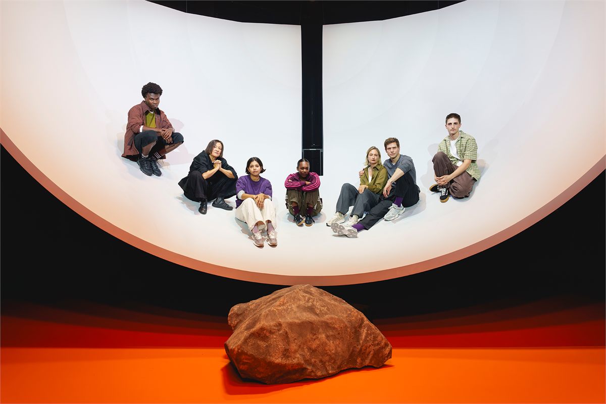 The company of Antigone Exits seated in Alex Lowde’s great white bowl at the Minerva Theatre. Photo by Andy Paradise