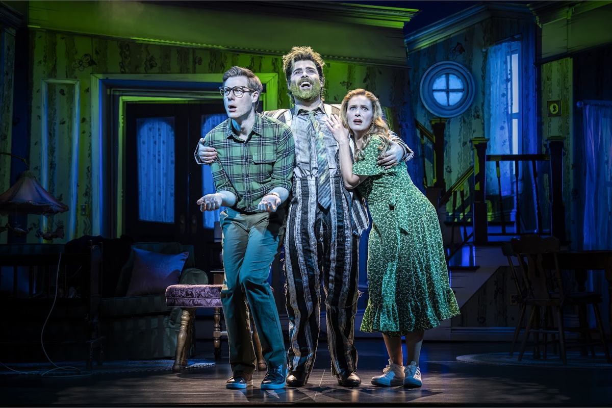David Fynn as Beetlejuice with the newly dead Maitlands in Beetlejuice The Musical at the Prince Edward Theatre