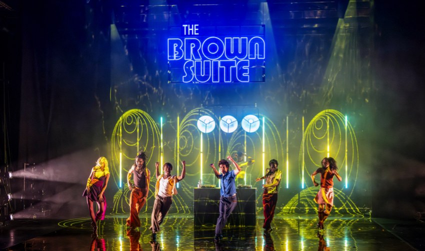 The company of The Brown Suite. Photo: Deborah Jaffe The company of The Brown Suite on stage beneath the club sign at Richmond Theatre