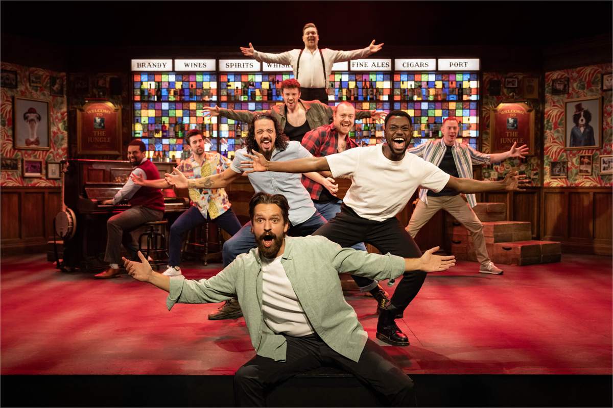 The 2026 touring company of The Choir of Man on the show's pub set. Photo by Mark Senior