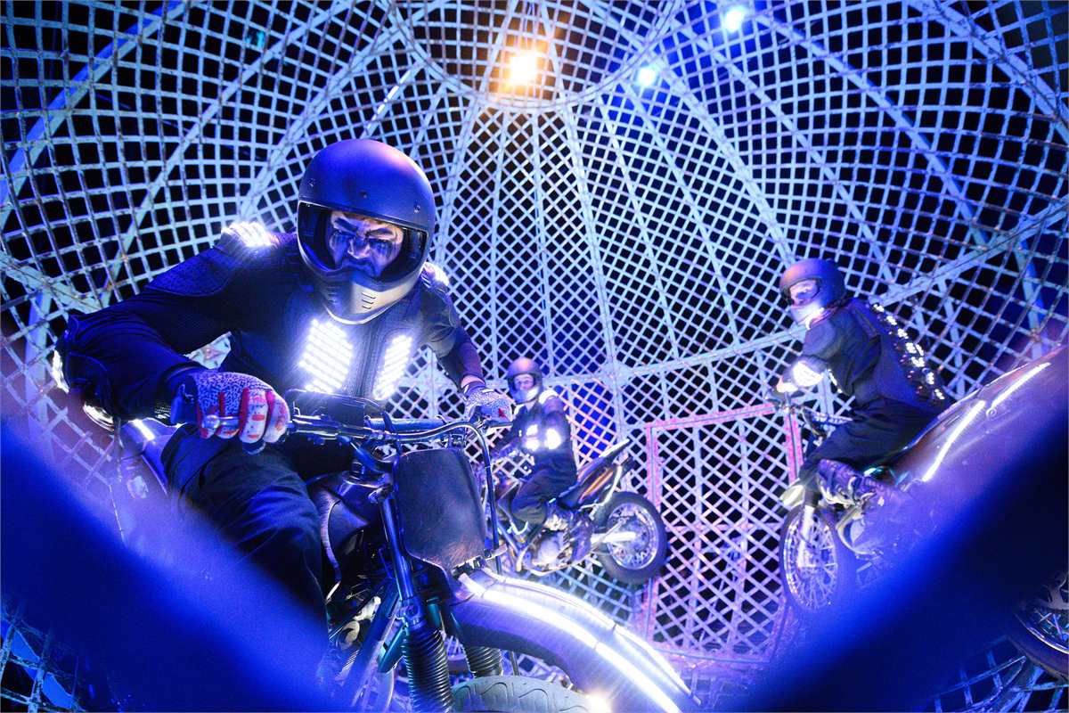 A rider in the Globe of Death, with two more motorcyclists behind, in Cirque Berserk! at the Garrick Theatre. Photo by Jonathan Hordle
