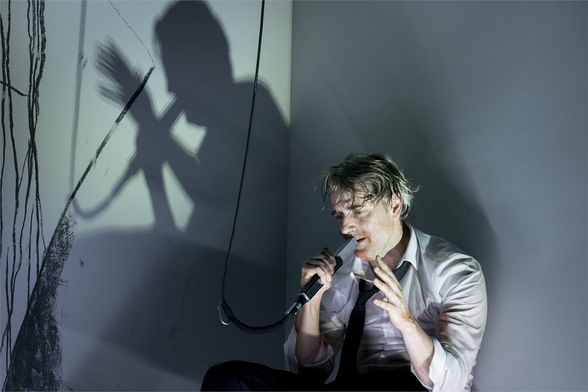 Jens Harzer in De Profundis. Photo: Jörg Brüggemann Jens Harzer with a microphone in De Profundis at the Coronet Theatre