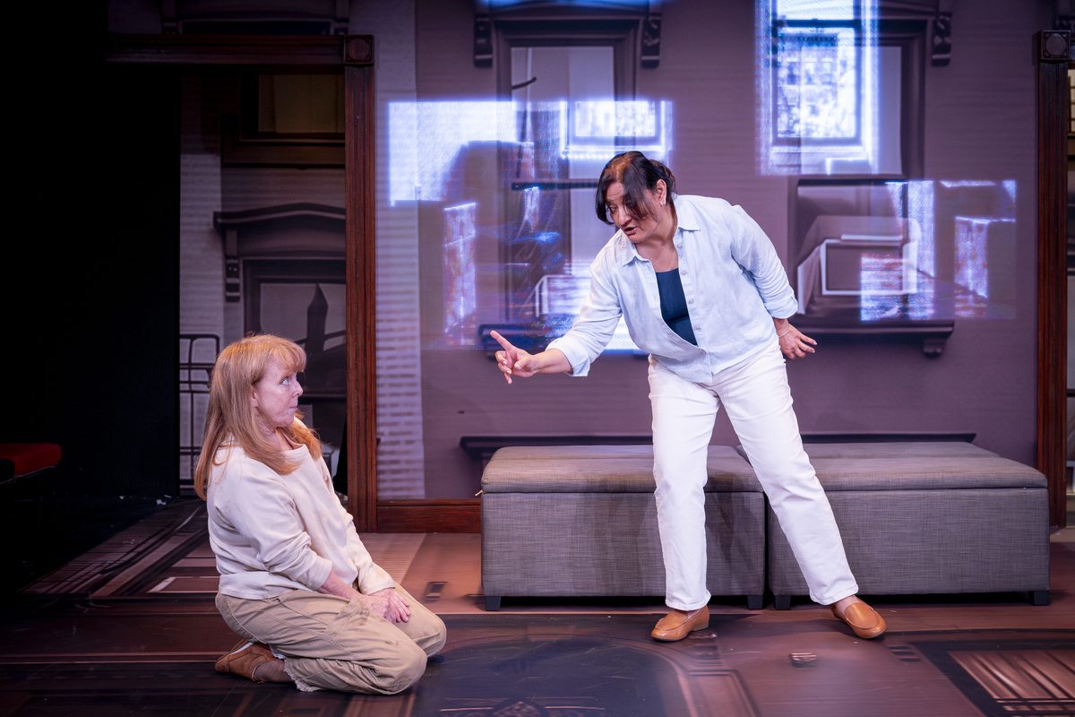 A woman kneeling on the floor as Sarita points at her in Dog Mom at Southwark Playhouse Borough