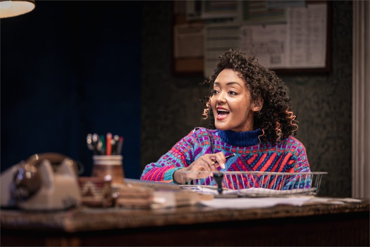 Alexandra Mardell as Rita at Frank’s desk in Educating Rita at Curve, Leicester. Photo by Jonathan Pryke