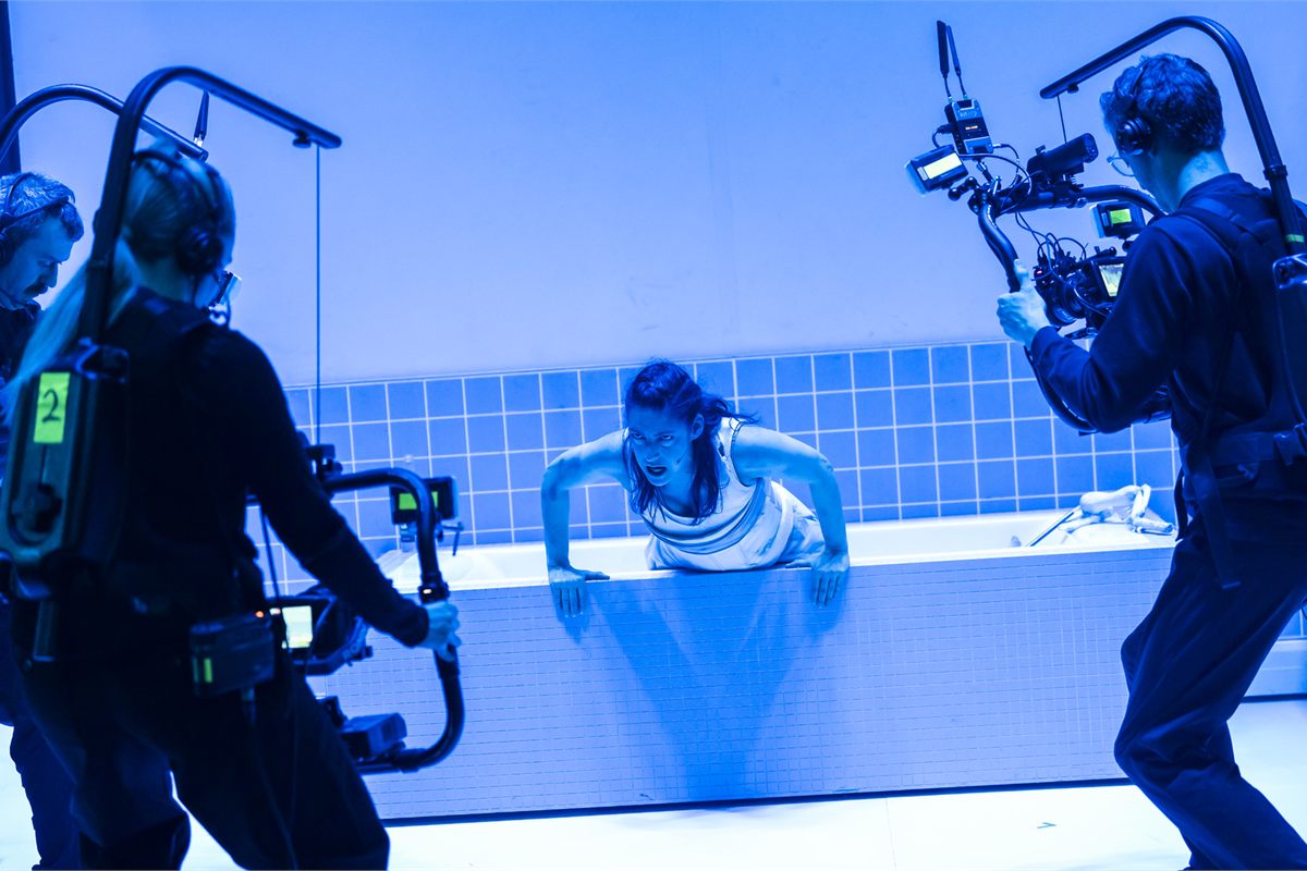 Mariam Wallentin with the onstage camera operators in English National Opera's Angel's Bone. Photo by Tristram Kenton