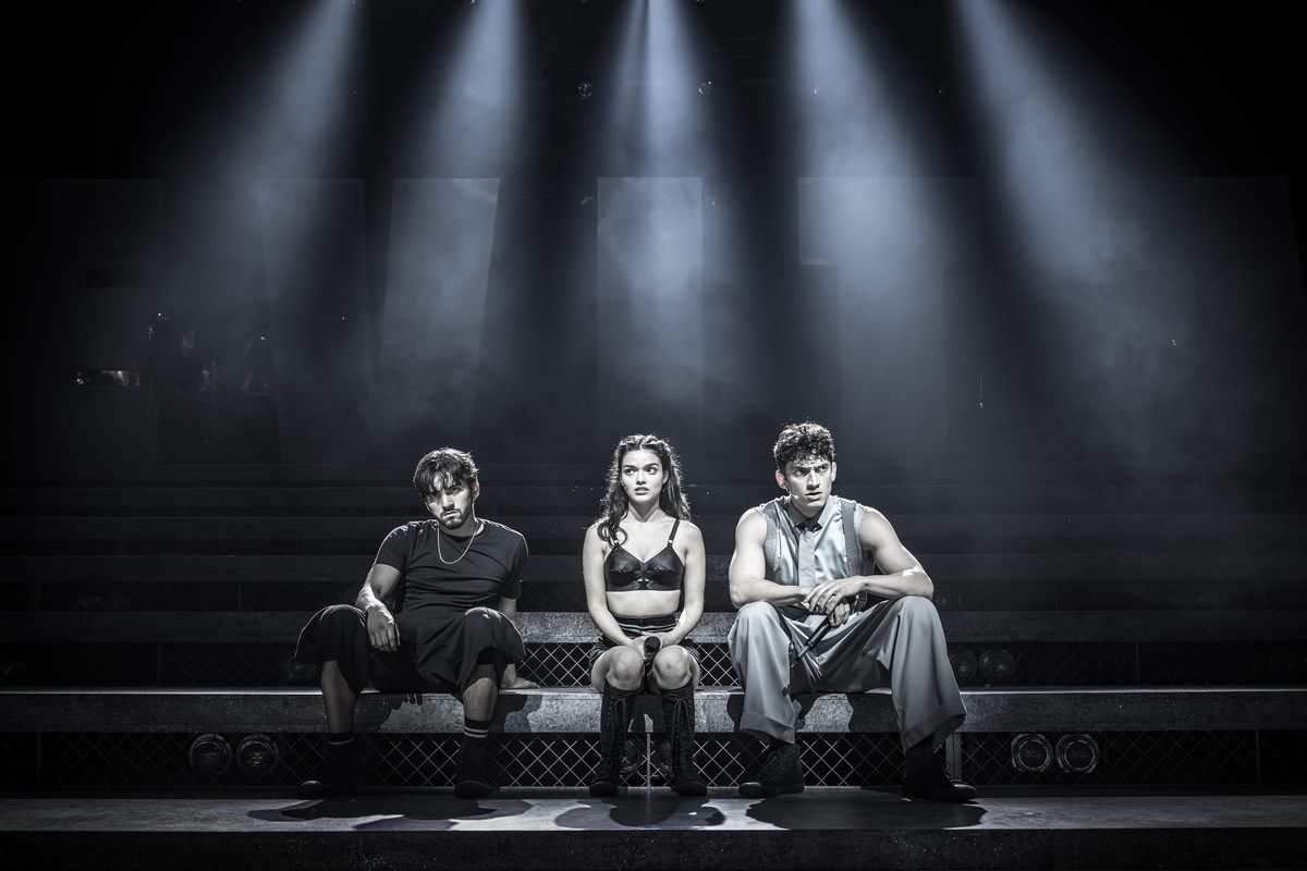 Diego Rodriguez as Che, Rachel Zegler as Eva Perón and James Olivas as Juan Perón in Evita at the London Palladium. Photo by Marc Brenner