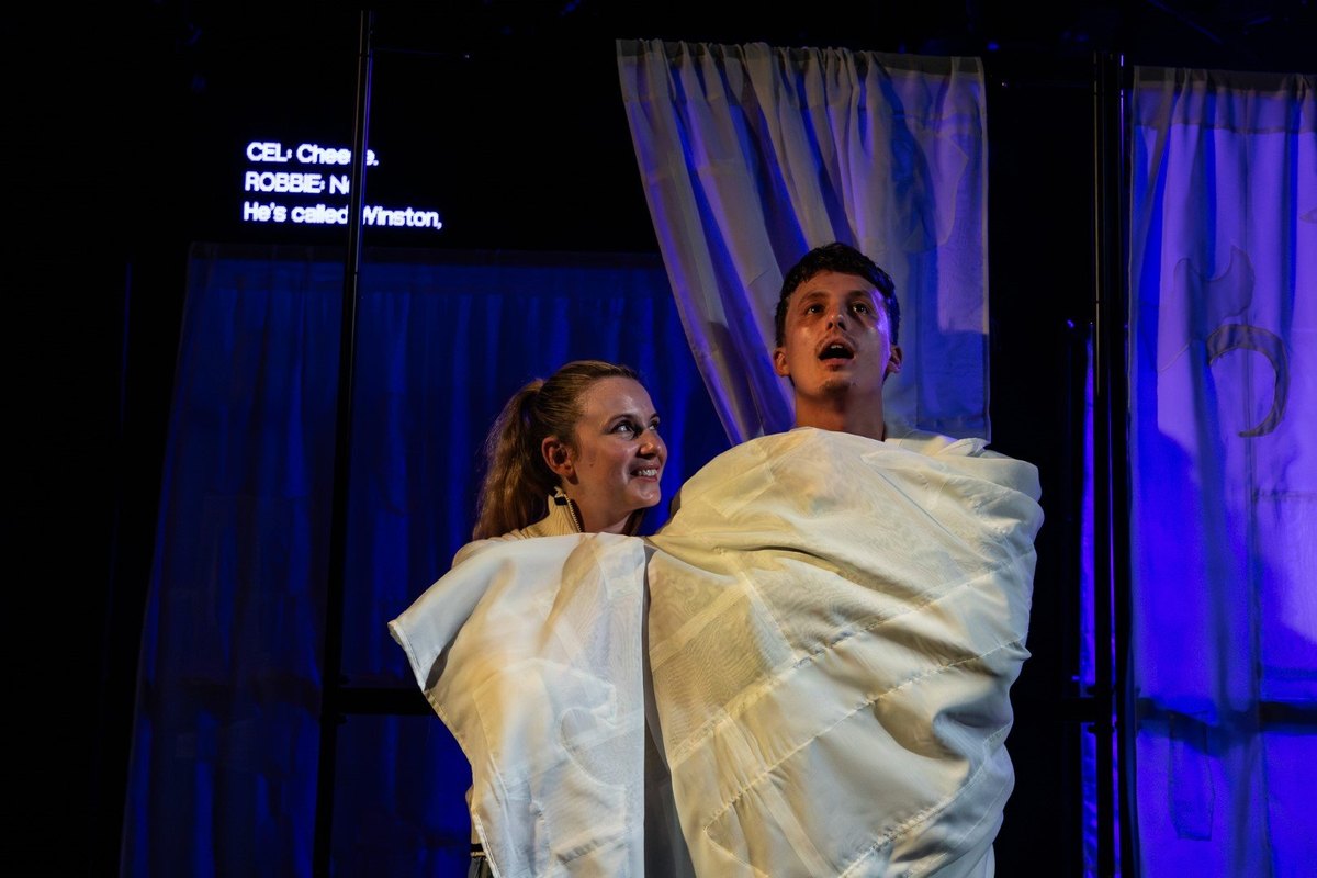 Tabitha Detroit as Cel and Joseph Clarke as Robbie, wrapped in white sheets, in Flock at the Jack Studio Theatre