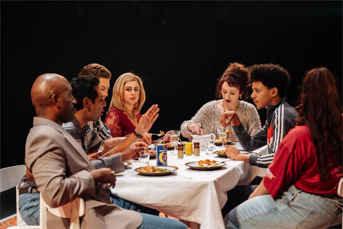 The company of Ilford Boy around the family dinner table at the Donmar Warehouse. Photo by Helen Murray