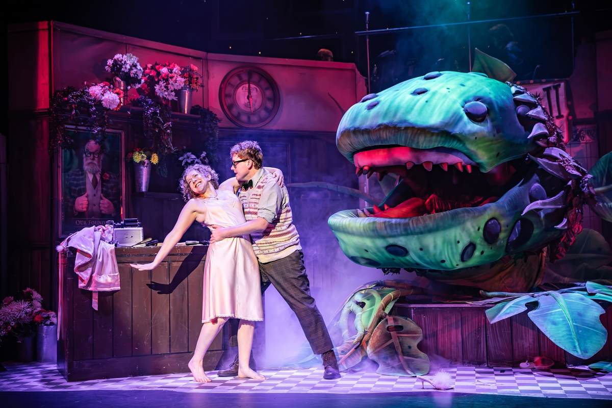 Leigh Quinn (Audrey) and Scott McClure (Seymour) with Audrey II in Little Shop of Horrors at Exeter Northcott Theatre. Photo by Craig Fuller