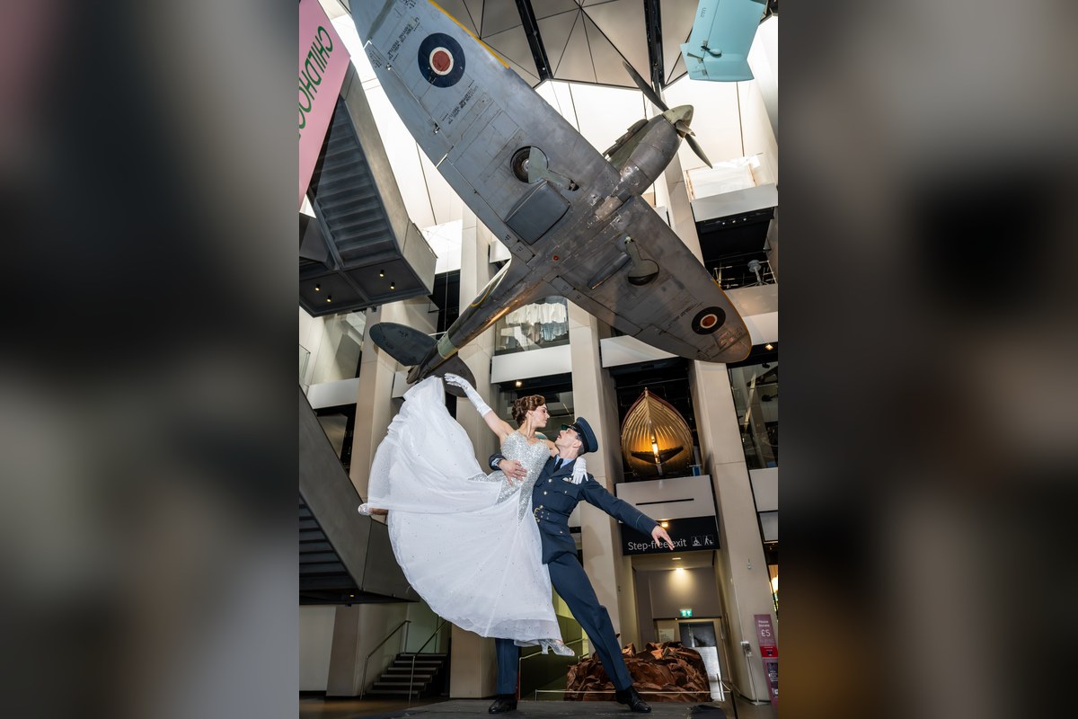 Katrina Lyndon (Cinderella) and Reece Causton (Harry the Pilot) beneath the Spitfire at IWM London. Photo by Craig Sugden