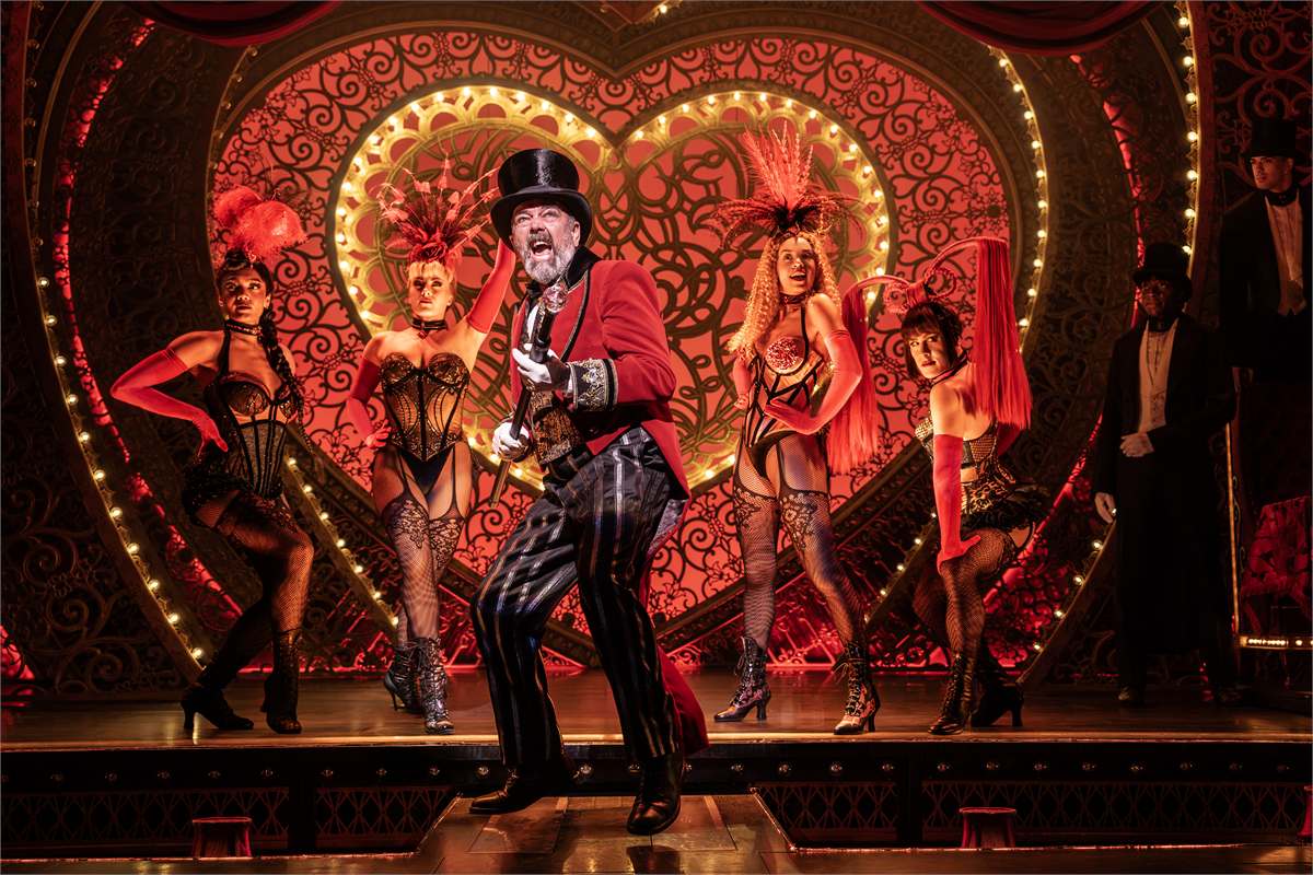 Harold Zidler and the Moulin Rouge dancers in Moulin Rouge! The Musical at the Piccadilly Theatre. Photo by Johan Persson