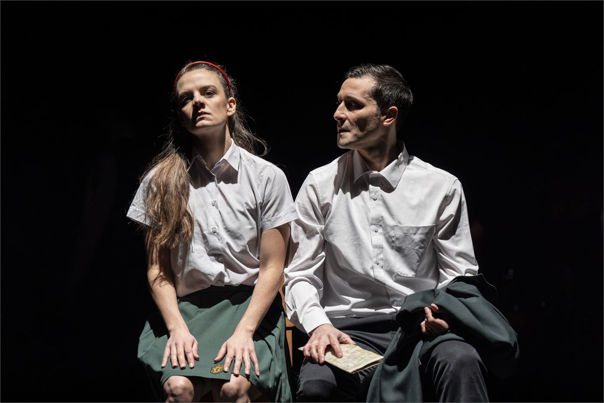 Two performers in school uniform in The Nature of Forgetting by Theatre Re. Photo by Ellie Kurttz