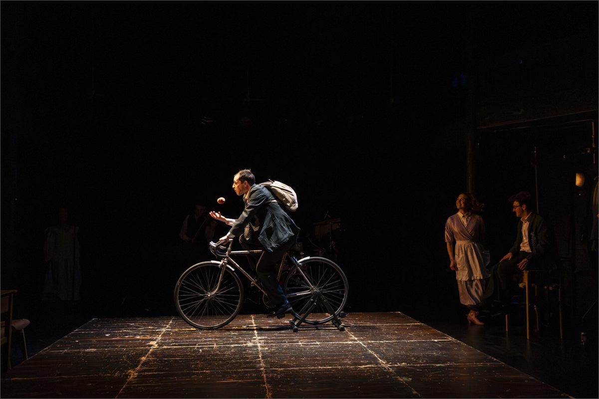 The bike sequence in The Nature of Forgetting by Theatre Re. Photo by Ellie Kurttz