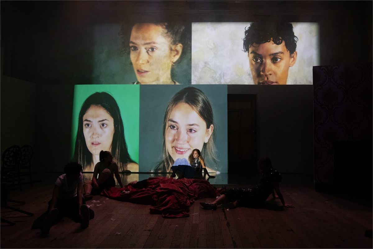 The four Ninas, Maya Bartley O'Dea, Samantha Begeman, Nina Bowers and Gemma Barnett, on screen in NINA at Battersea Arts Centre. Photo by Ali Wright