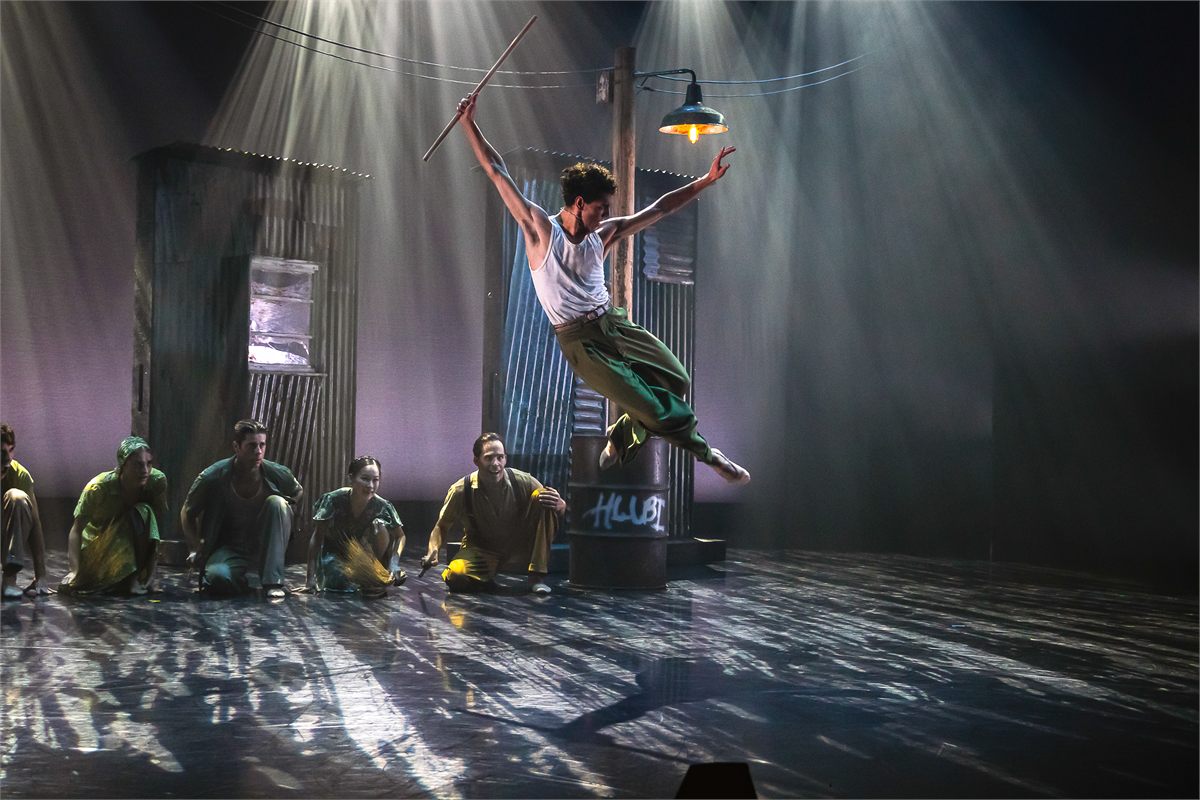 Antoni Cañellas Artigues in mid-air with a fighting stick in Fools for Northern Ballet. Photo by Colleen Mair