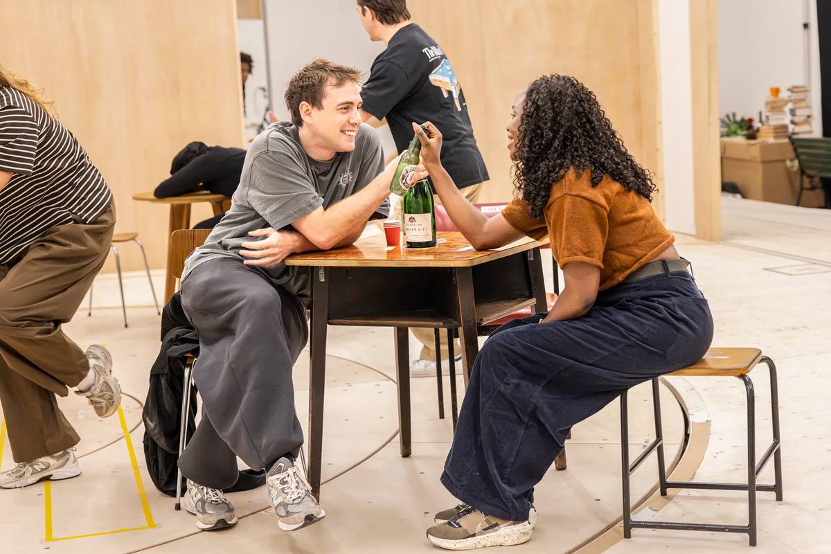 Two members of the One Day company at a table in the rehearsal room. Photo by Pamela Raith