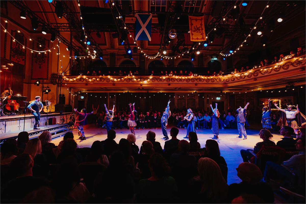The company of Ceilidh the Musical leading a dance at Shoreditch Town Hall. Photo by Luke Dyson