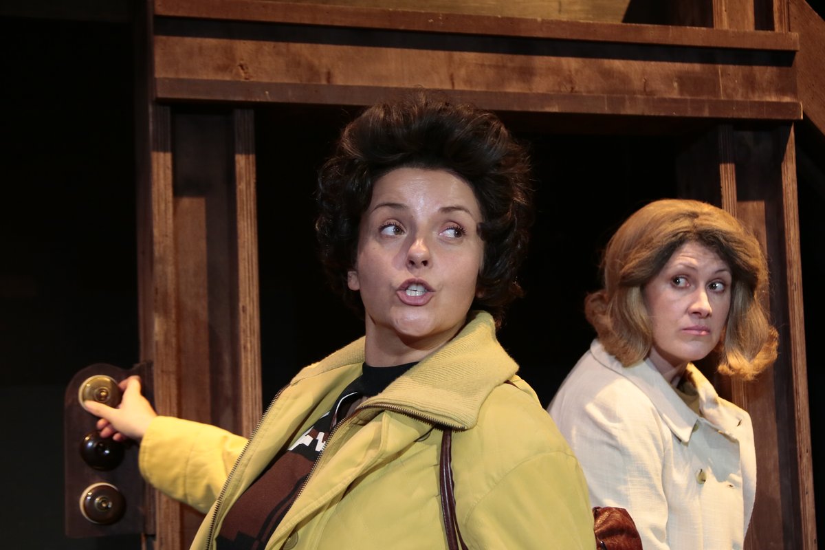 Two of the mothers, one in a yellow coat, in The Revlon Girl at Park Theatre