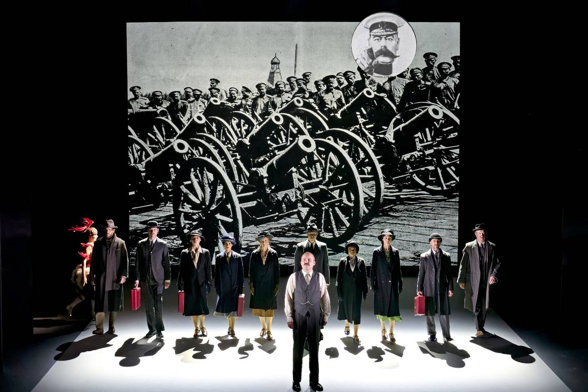 The company of The Standard of Living in front of a projected First World War photograph. Photo by Manuel Harlan