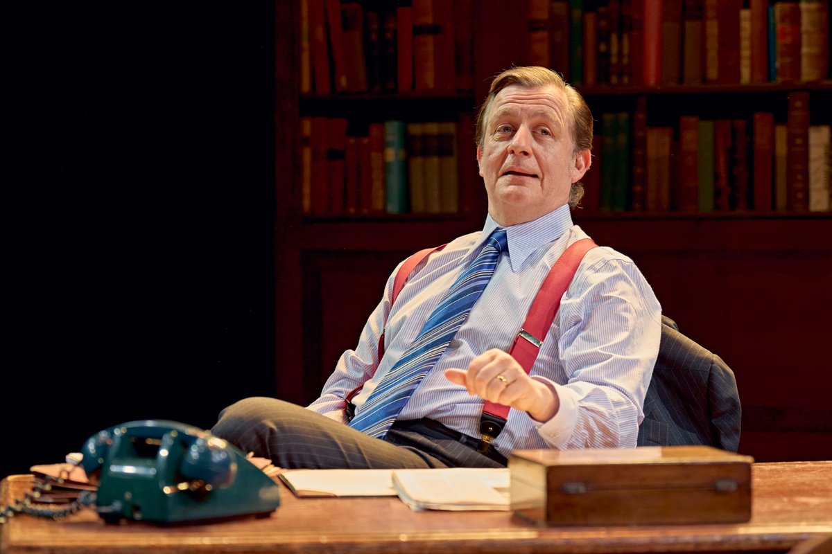 One of the three politicians at his desk in red braces in The Gang of Three at Richmond Theatre