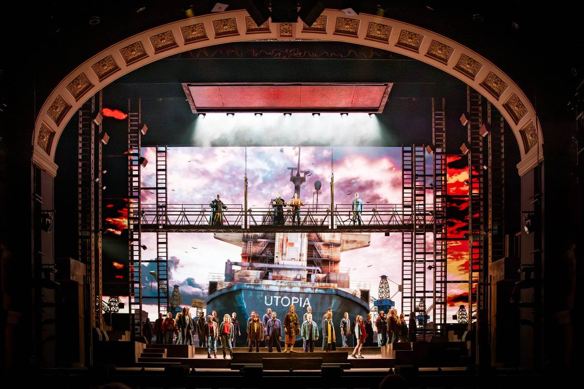 The ensemble of The Last Ship in front of the projected hull at the Theatre Royal Drury Lane