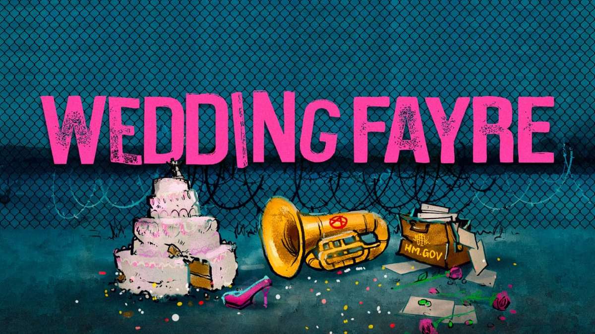 Key art for Wedding Fayre: the title in pink capitals above a toppled wedding cake, a brass horn marked with an anarchy symbol and a spilled HM.GOV briefcase, in front of a razor-wire fence
