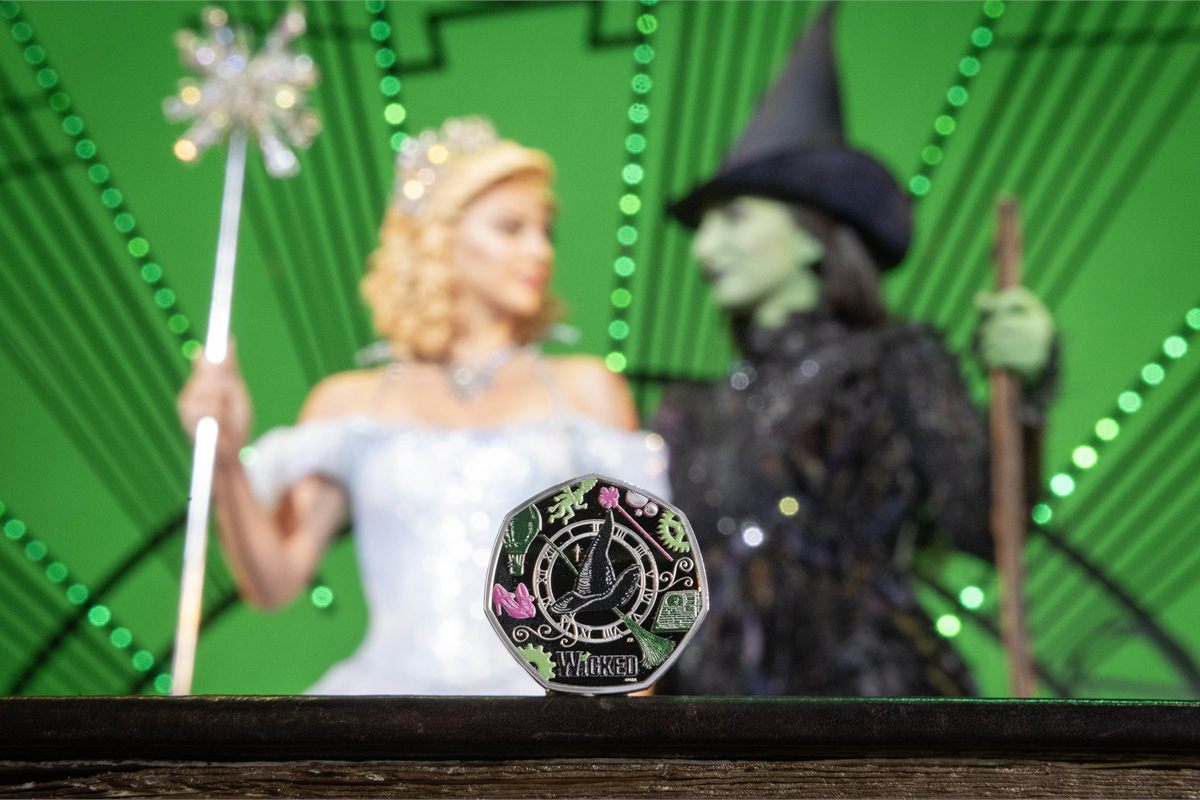 Zizi Strallen (Glinda) and Emma Kingston (Elphaba) with The Royal Mint's Wicked 50p coin. Photo by Matt Alexander/PA Media Assignments